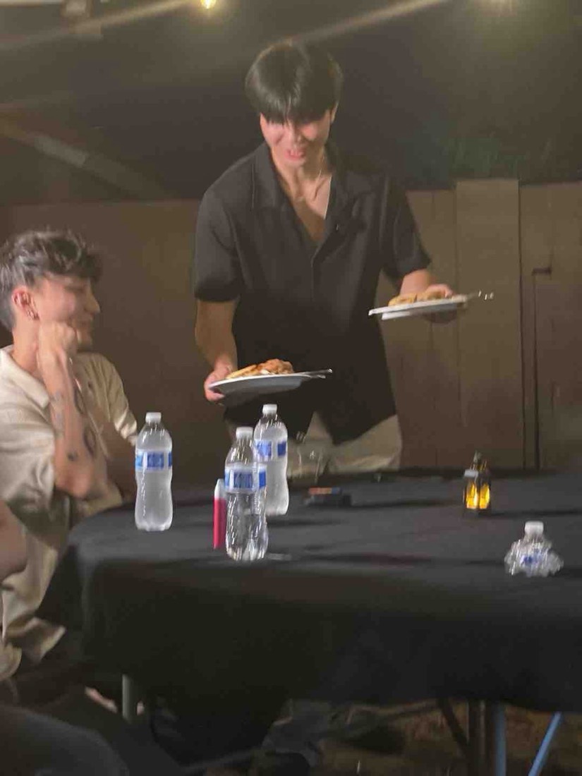 The host carrying plates to the table at the Founder Dinner